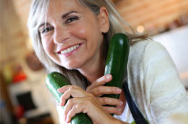 Seniorin hält in jeder Hand eine Zucchini © goodluz - fotolia.com